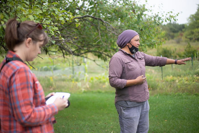 Nora Hertel (left) takes notes during a tour with Jessika Greendeer, seedkeeper and farm manager for Dream of Wild Health