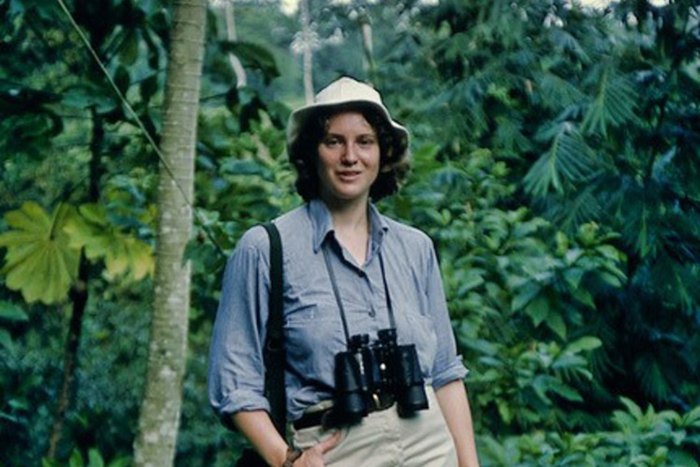 Photo of Lynn Best with binoculars in beautiful jungle