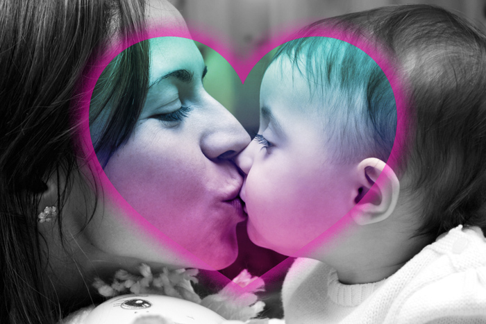 Photo showing mother kissing her baby inside a colorful heart