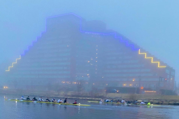 a building in fog lit in blue and yellow