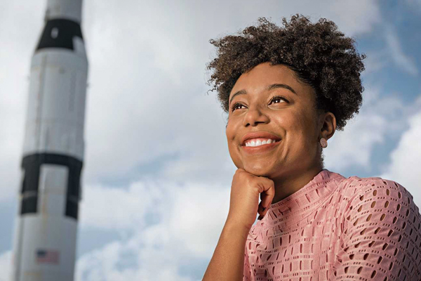 Tiera Fletcher with a space rocket behind her