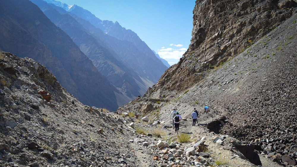 People hiking through a rocky mountain pass