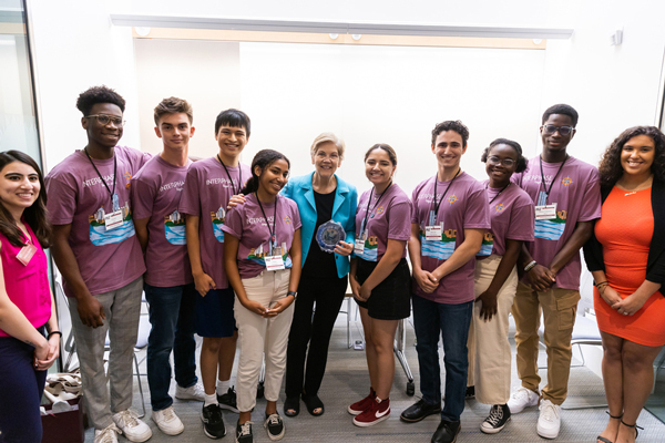 Elizabeth Warren surrounded by female and male students