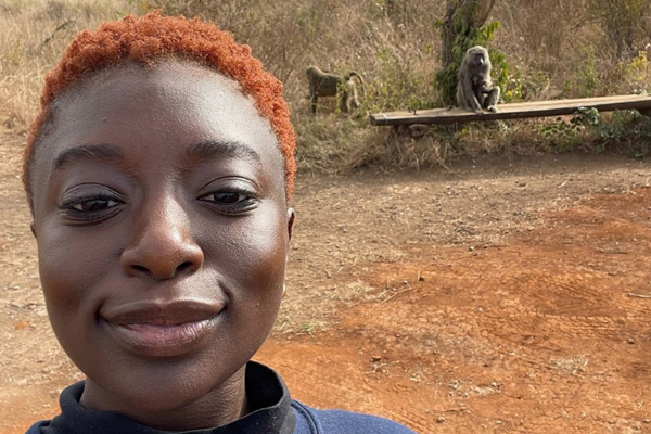 Mariama Ndiaye takes a selfie, with monkeys in background