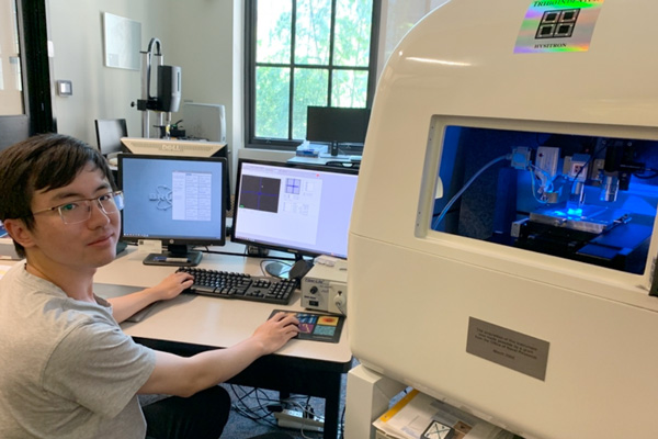 MIT graduate student Jiahao Dong with the nanoindentation machine