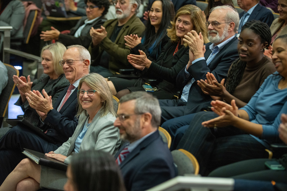 Sally Kornbluth being applauded by an audience