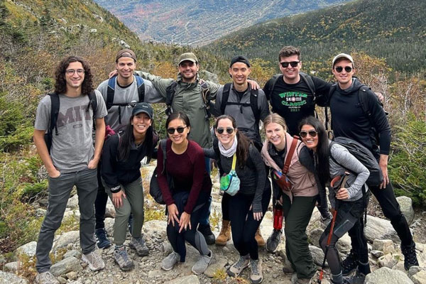 11 students pose with the scenic White Mountains of New Hampshire in background