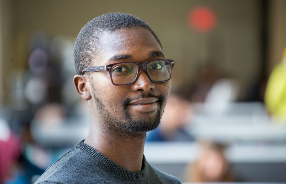 Tsanni smiles while indoors on campus