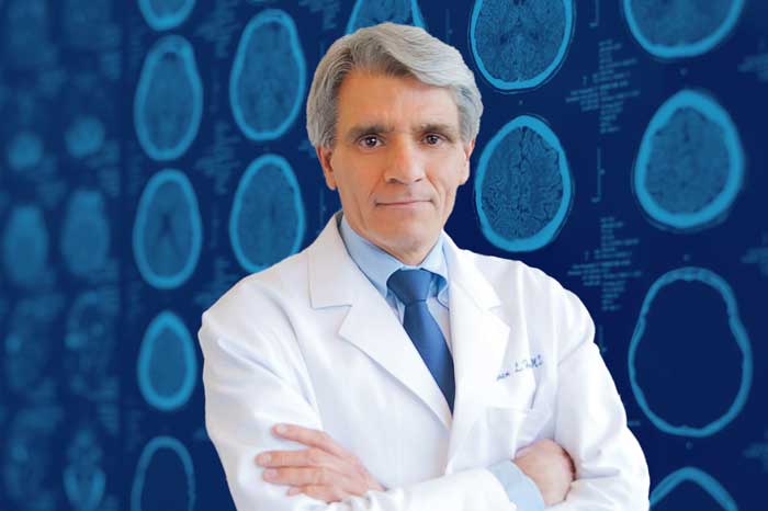 Stephen Hauser portrait with brain x-rays in background