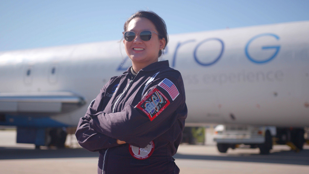 Sheila Xu standing next to an airplane