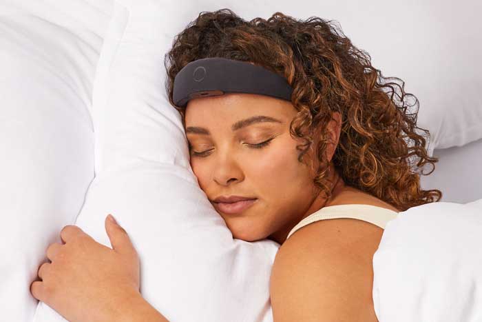 Woman sleeps with the Elemind bandana, which has a sensor on the forehead