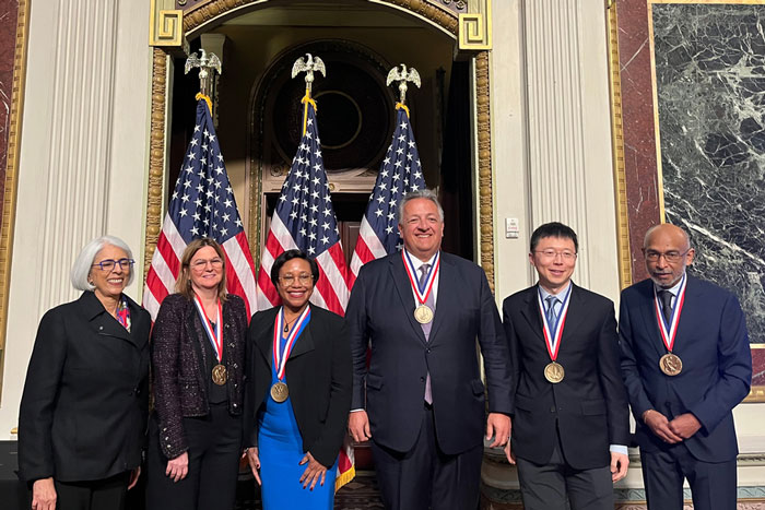 6 people at podium including 4 faculty