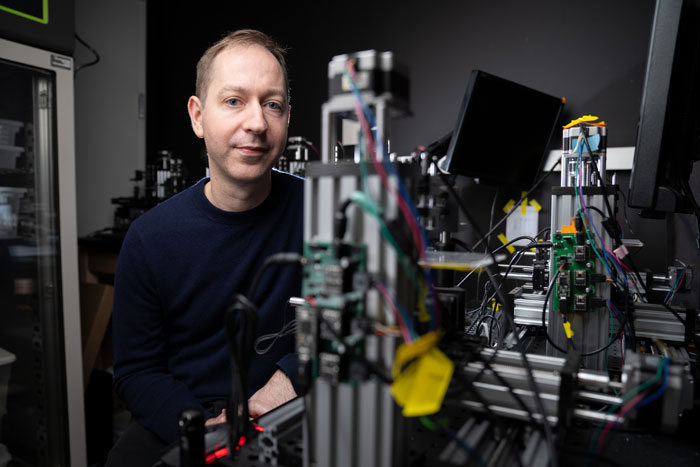 Steven Flavell in the lab with desktop equipment