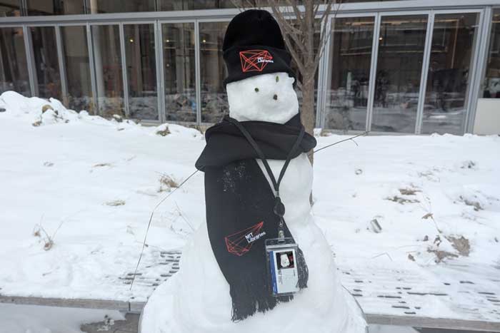 a snowman at MIT with a MIT beanie and scarf