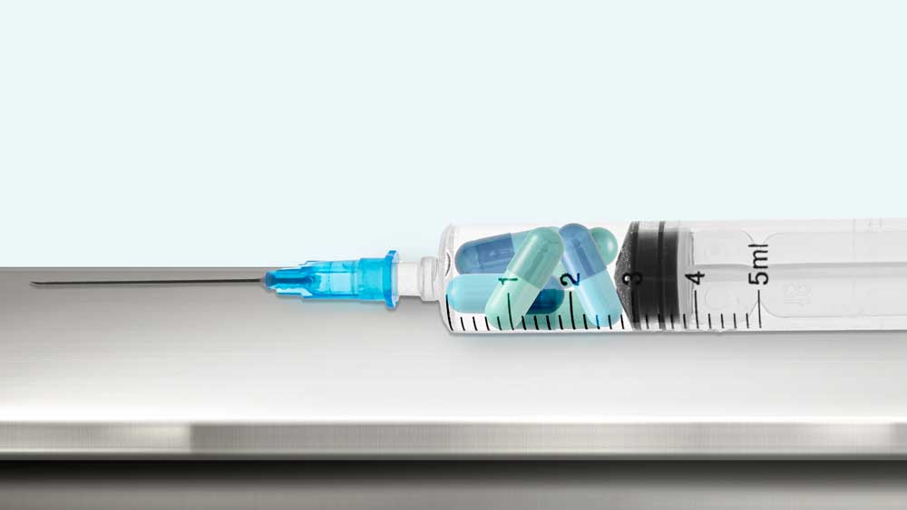 A syringe filled with medicinal capsules