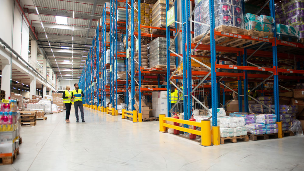 two workers in a large warehouse