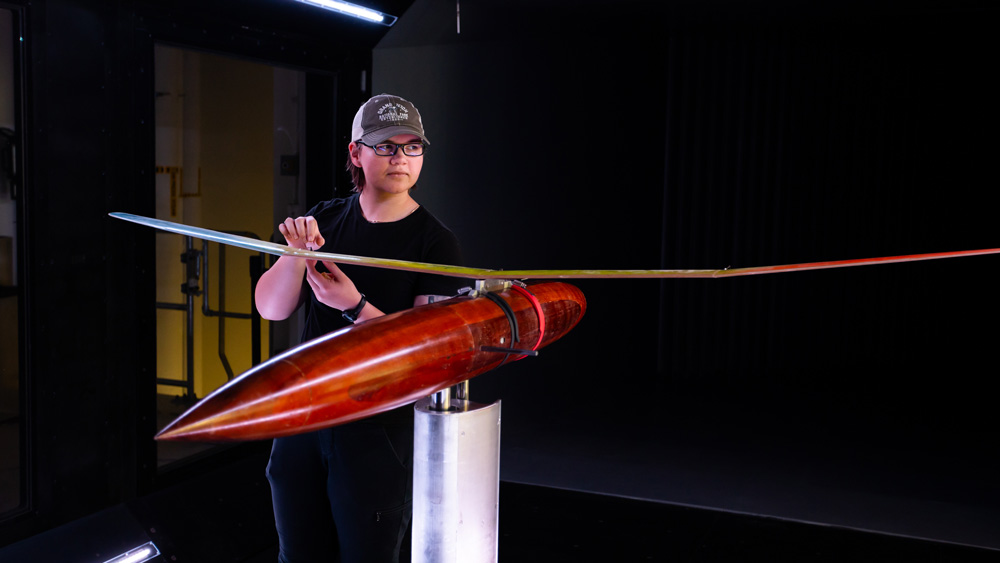 student with a plane design