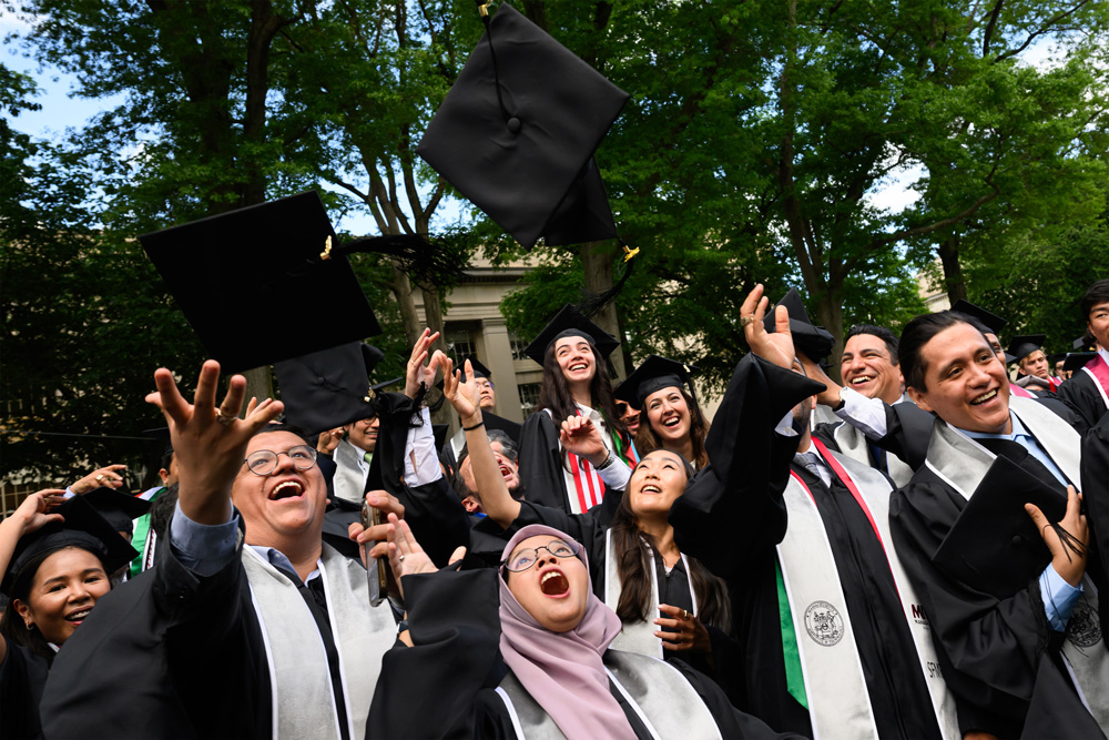 group of grads throwing hat in the air