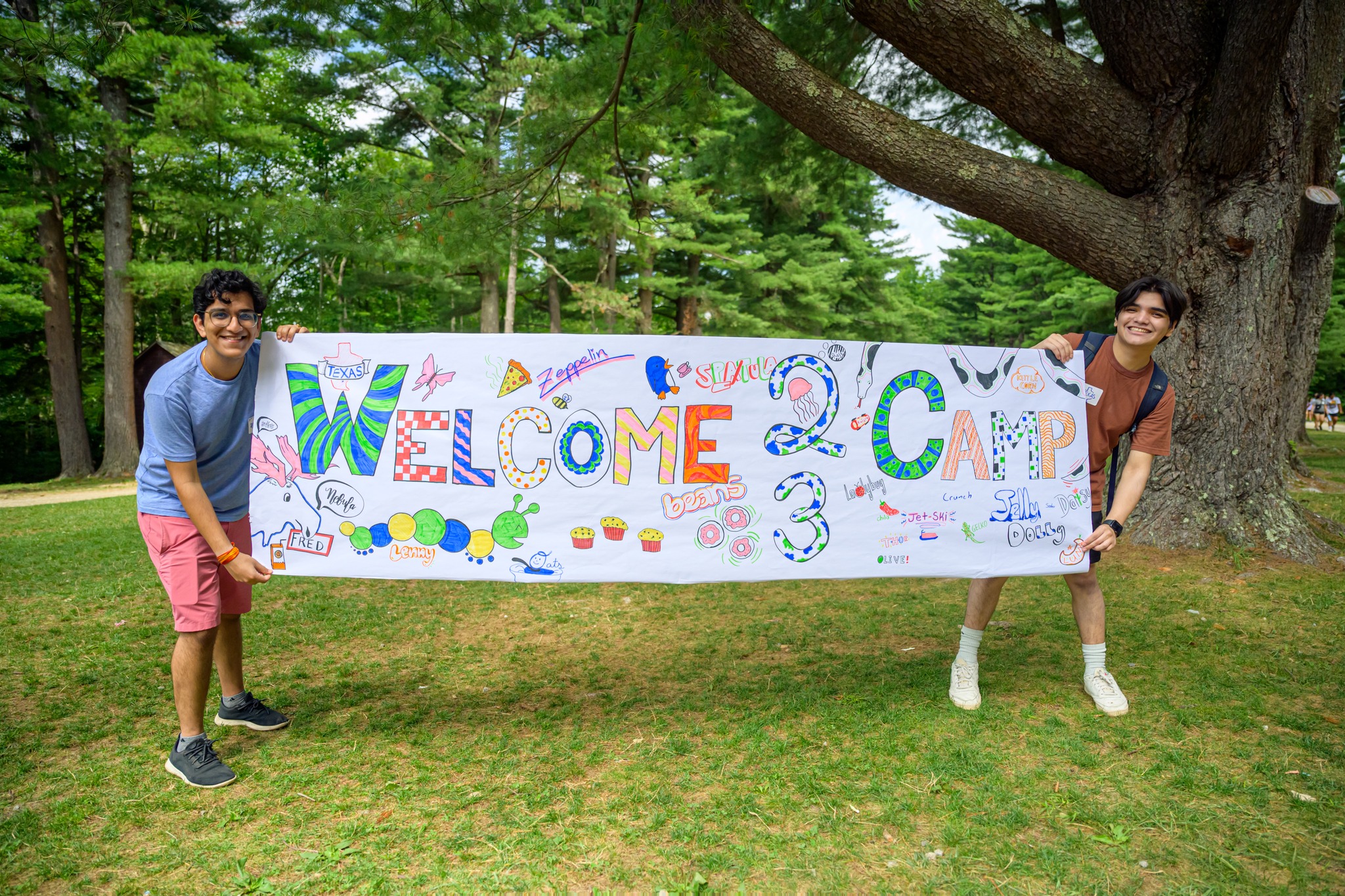 Two counselors hold up a sign with Kesem2023