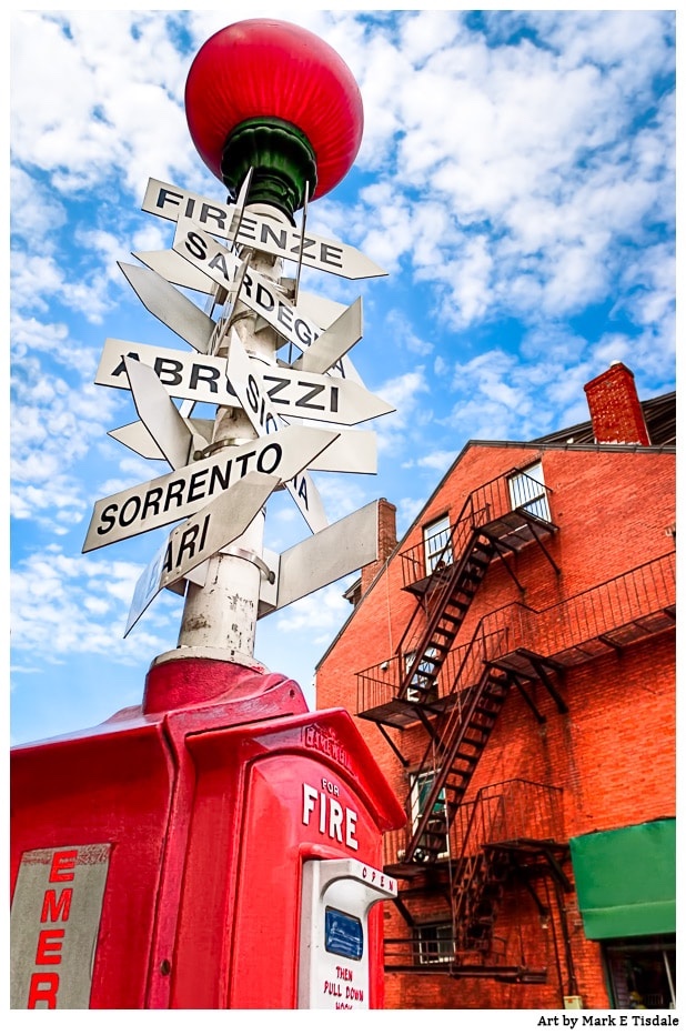Boston fire box with signs pointing to Italian cities