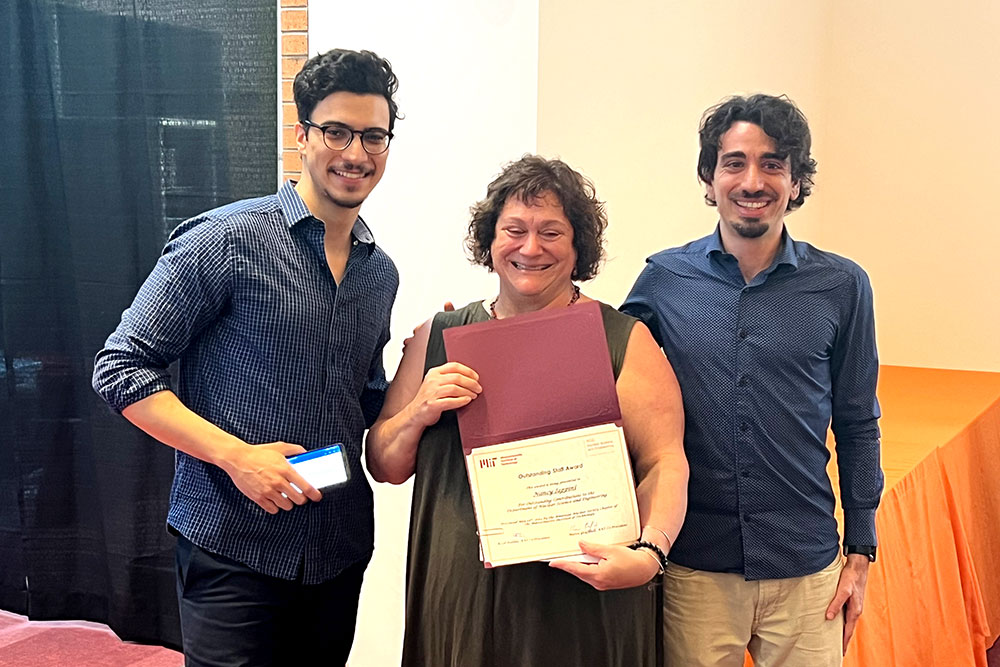 Nancy Iappini in the center holding an award certifical with ANS Co-President Assil Halimi on the left and and Marco Graffiedi on the right, MIT