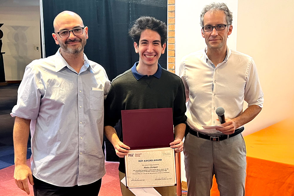 Marco Graffiedi in the center holding an award certificte with Matteo Buccito the left and Jacopo Buongiorno to the right, in a row, MIT
