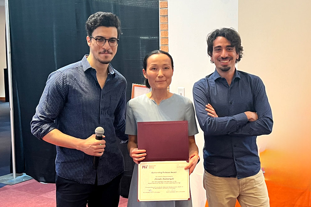 Haruko Wainwright in the center holding an award certifical with ANS Co-President Assil Halimi on the left and and Marco Graffiedi on the right, MIT