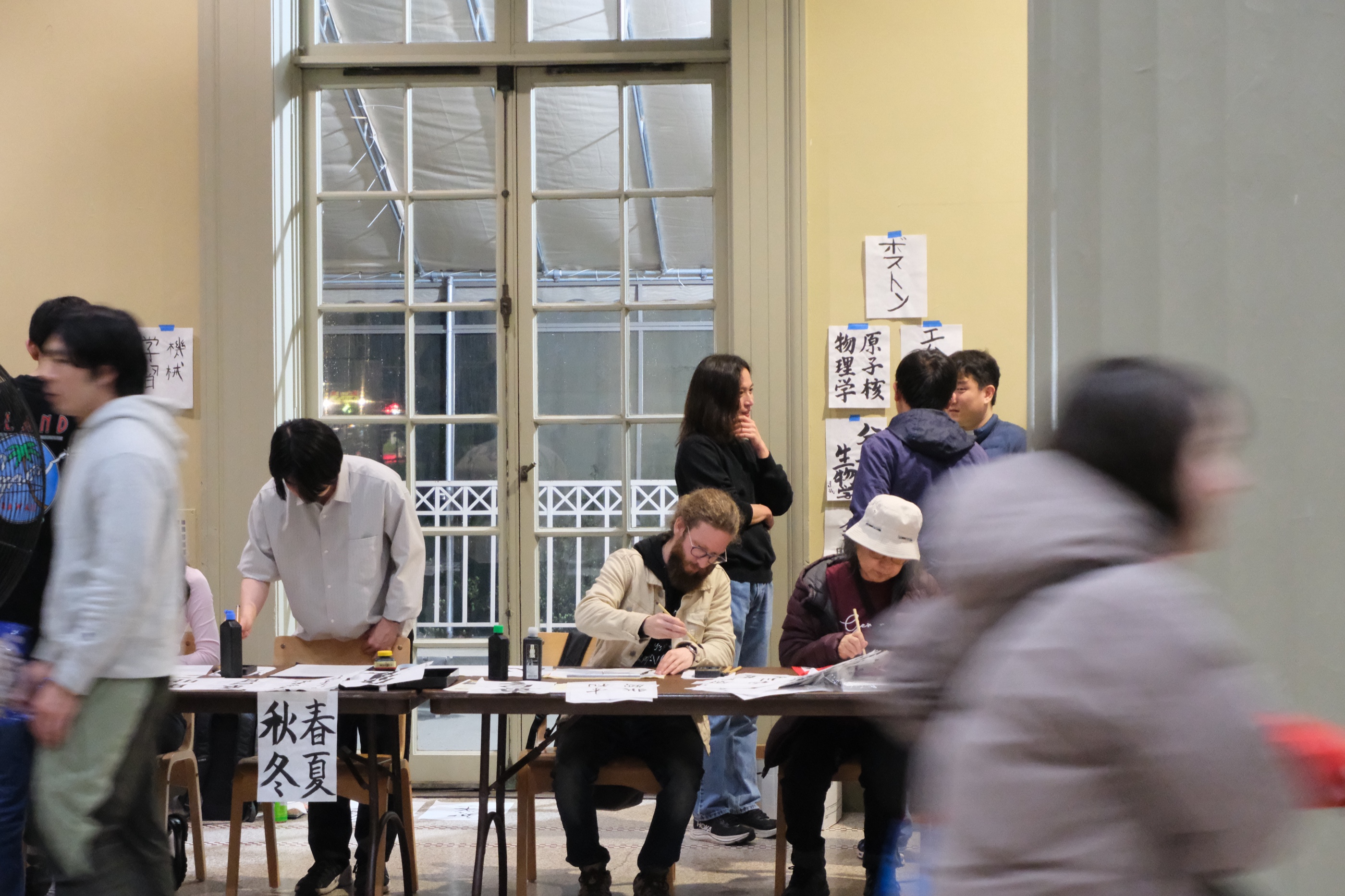 Calligraphy booth and visitors at Hanami Festival